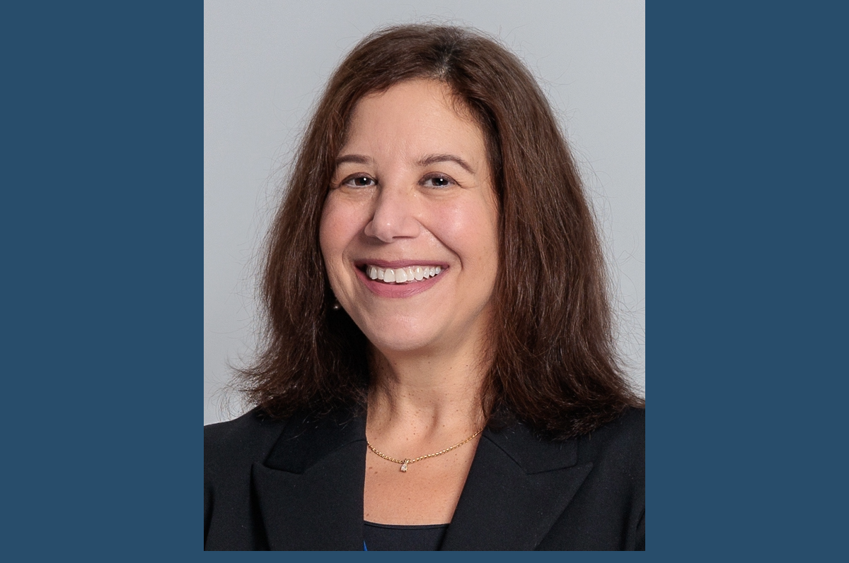 Head and shoulders portrait of smiling woman with brown hair